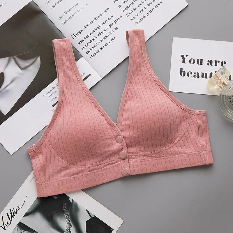 Soft pink ribbed wireless bra with front buttons, ideal women’s undergarment for comfort and support.
