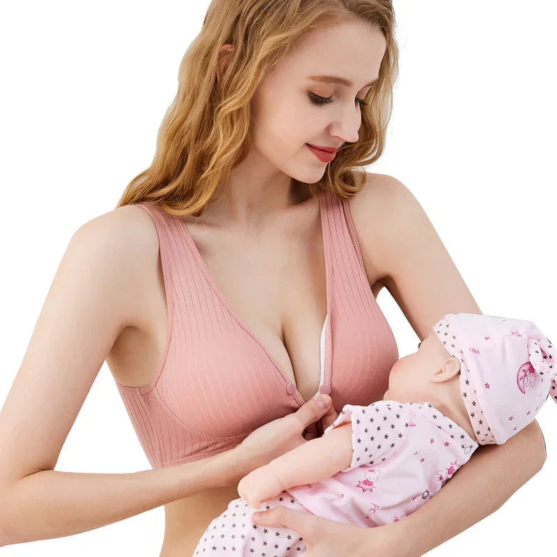 Woman in pink nursing bra breastfeeding baby, showcasing comfortable undergarment for everyday wear