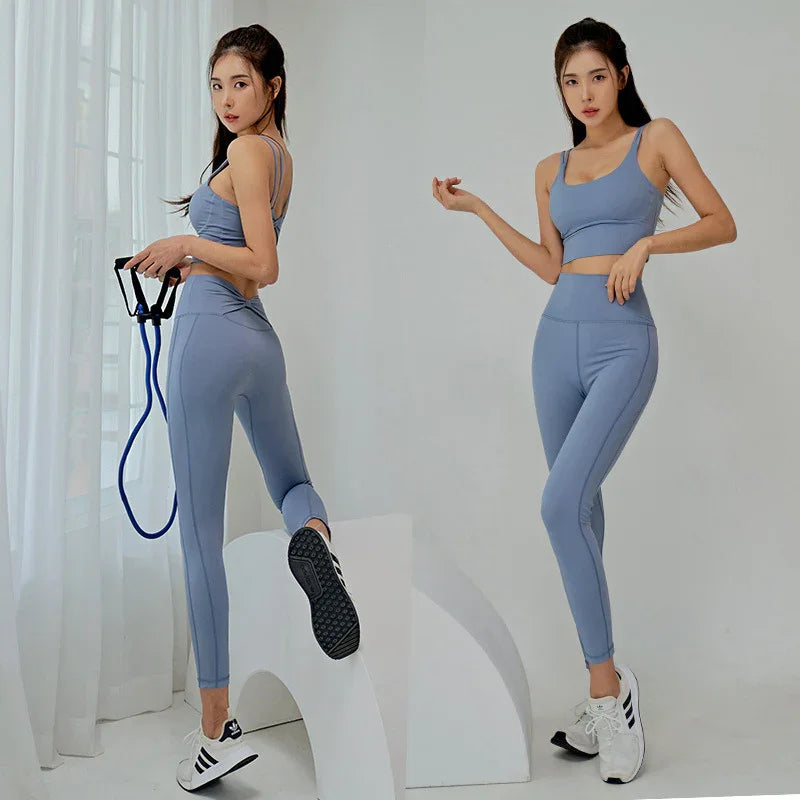 Woman modeling blue seamless sports bra and leggings set, supportive and comfortable activewear
