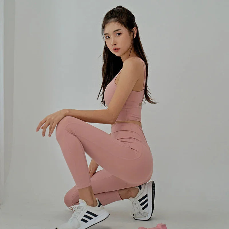 Woman in soft pink seamless undergarments, posing in a minimal studio for comfort and support