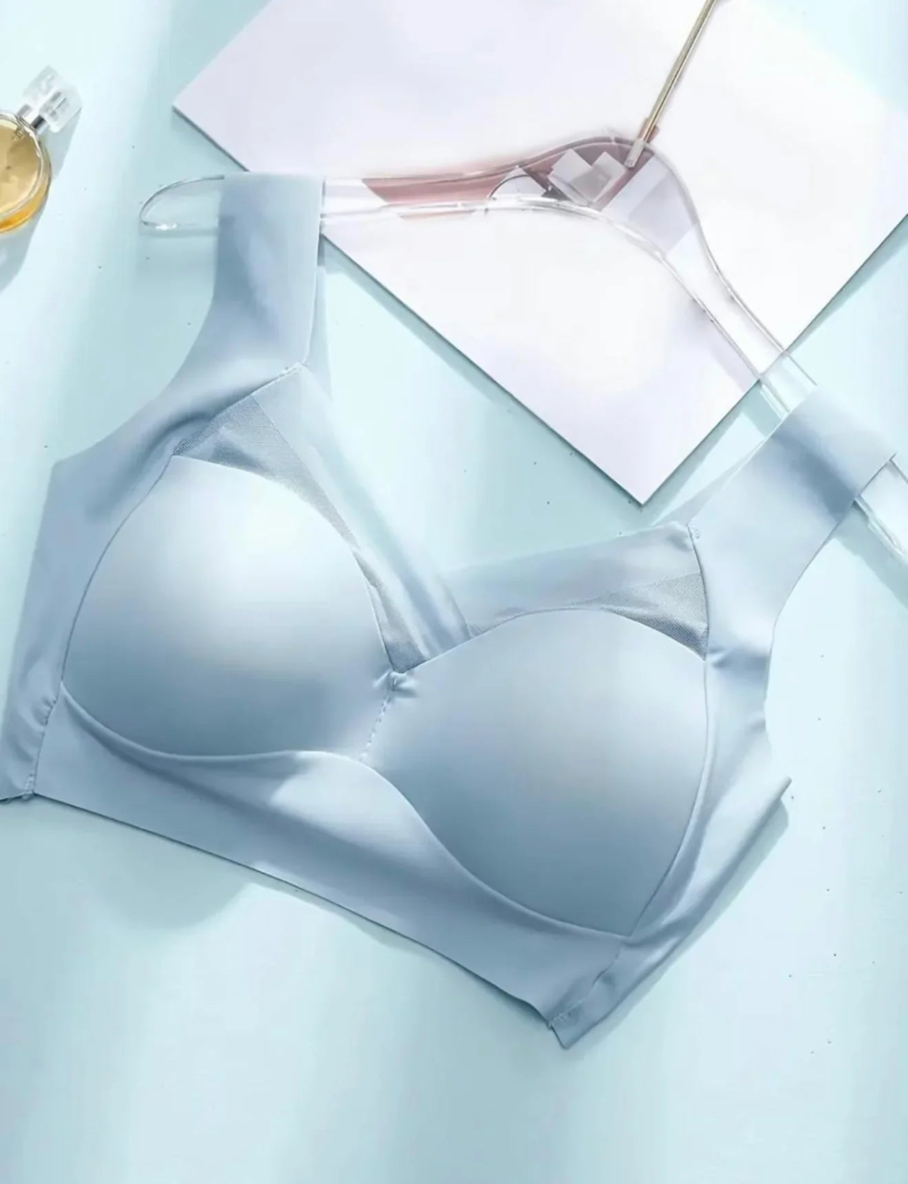 Soft light blue wireless bra with wide straps, designed for everyday comfort and support.