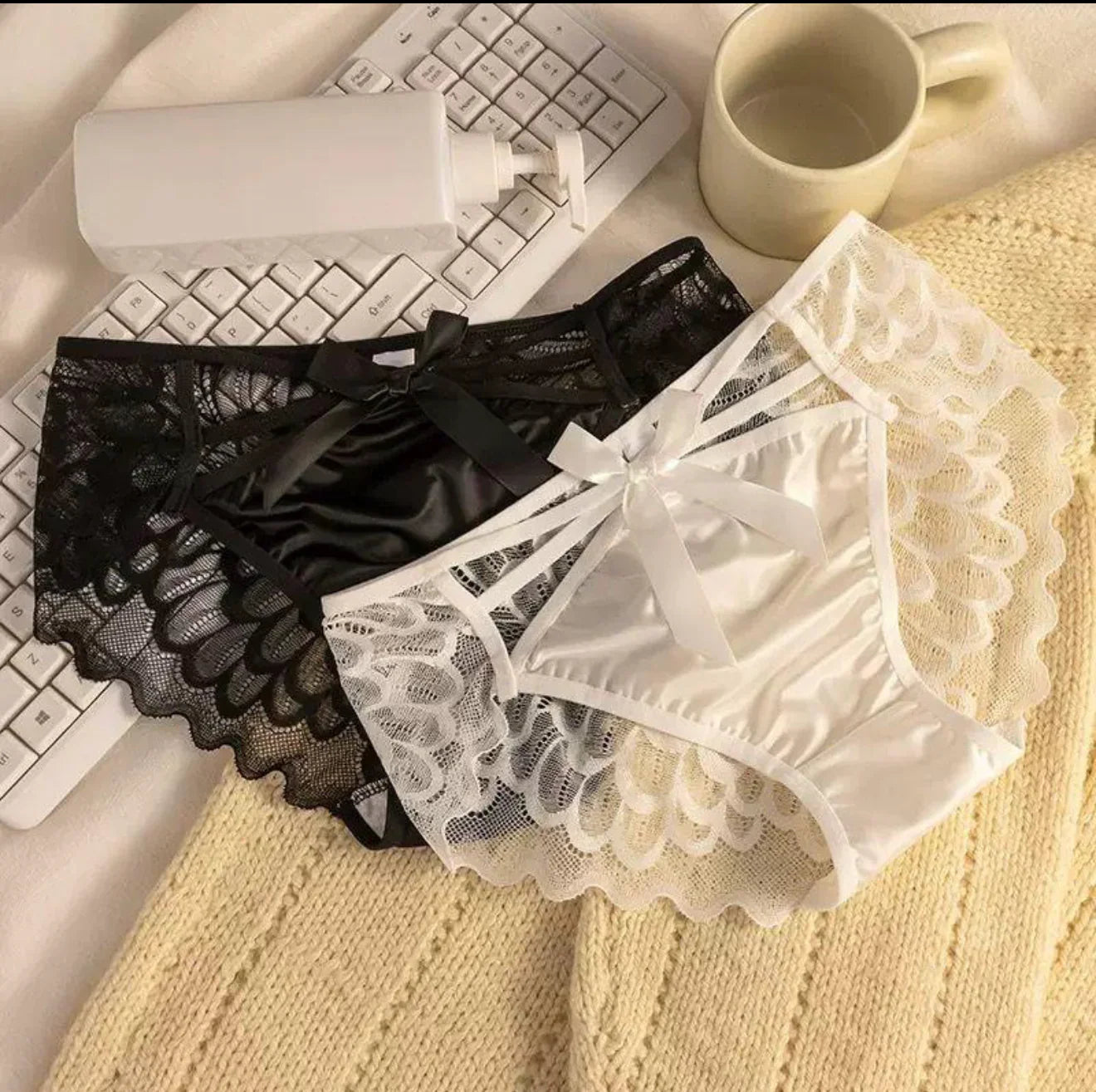 Black and white lace women’s panties with bows, displayed for comfort and elegance