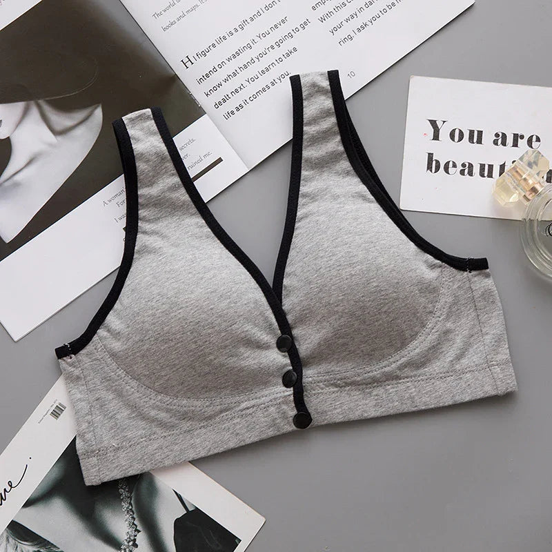 Soft grey women's everyday comfort bra with black trim, front buttons, and supportive design